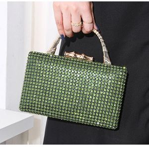 Macro detail of green rhinestone evening bag with elegant bamboo-shaped metal clasp