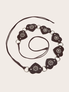 Detail of heart-shaped dark brown leather belt with silver metal studs and eyelets