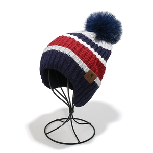 Detail of knit rib texture and superstar patch on a colorful striped winter hat
