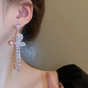 Detail of pink zircon butterfly tassel earring with pear-cut crystals on model