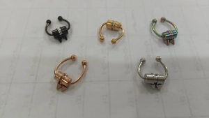 Detail of horseshoe magnetic nose rings in black gold rainbow rose gold and silver finish