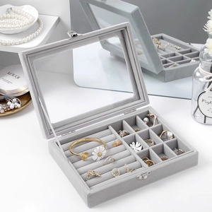 Gray velvet jewelry box with transparent glass lid and metal lock for rings and earrings