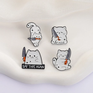 Set of four funny cartoon cat enamel pins featuring a cat holding a knife on white fabric