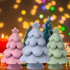 Three-tier Christmas tree candles in pink, blue, and green colors with star tops