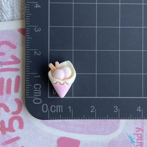 Detailed close-up of a pink and white mini resin ice cream cone accessory for DIY crafts