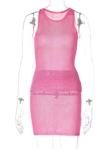 Close-up of pink knitted mini dress showing the fine mesh texture and metallic sheen fabric