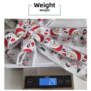 Close-up of rustic grey linen Christmas ribbon with Santa print on a digital scale weighing 24g
