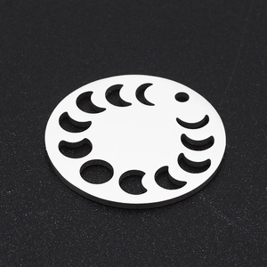 Detail of silver stainless steel moon phase pendant with cutout geometric design