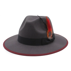 Dark grey felt fedora hat with red trim and vibrant feather accent for autumn fashion