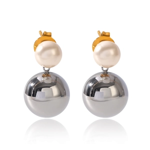 Detailed view of dual-ball earrings with white pearl and polished silver metallic sphere
