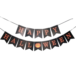 Close-up of black and orange paper Happy Halloween banner with a small pumpkin icon