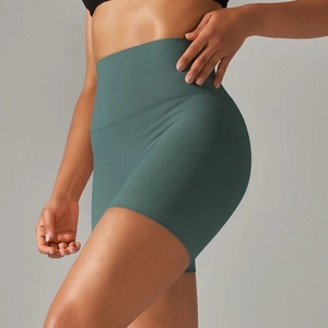 Detail view of teal high-waisted yoga shorts with double-sided brushed compression fabric