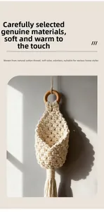 Detail of hand-woven cotton macrame wall hanging with natural wooden ring and tassels