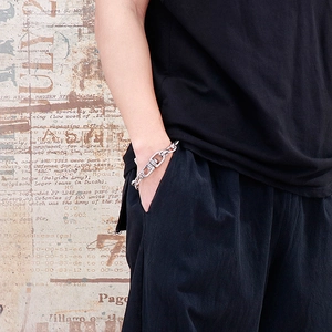 Retro silver stainless steel chunky chain bracelet shown on a male model's wrist