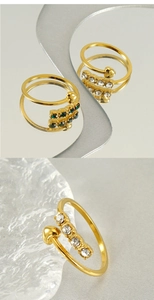 Detailed view of adjustable gold-plated ring with green and white round-cut crystals