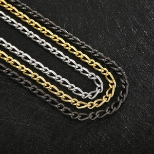 Macro shot of stainless steel twisted curb chains in gold, silver, and black finishes