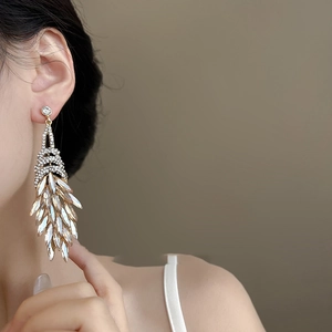 Elegant gold drop fringe earrings with sparkling white crystals for a luxury party look