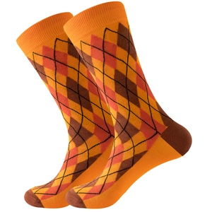 Detail of argyle knit mid-calf socks featuring orange and brown diamond patterns