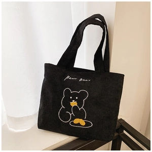 Close-up of black corduroy tote bag with cute bear embroidery and Bear Bear text
