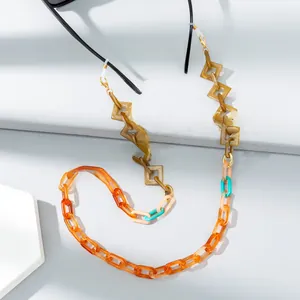 Detail of colorful acrylic eyeglass chain with tortoiseshell and multi-tone geometric links