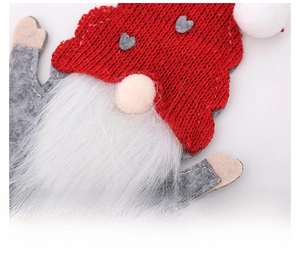 Detailed view of handmade Christmas gnome cutlery holder with red knit hat and white beard