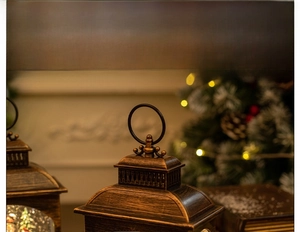 Close-up of vintage bronze Christmas lantern with metal handle and decorative top