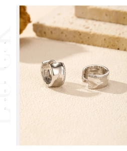 Macro shot of S925 sterling silver hoop earrings with clear hallmark and sparkling zircon stones