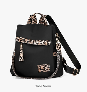 Detail view of water-resistant oxford backpack featuring leopard print accents and gold hardware
