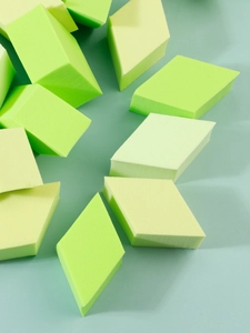 Macro detail of diamond shaped non-latex makeup sponges in lime green and yellow green