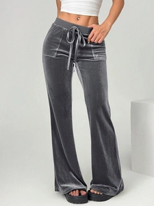 Detail of high-waist charcoal grey velvet flared trousers with adjustable drawstring
