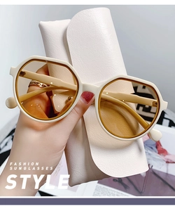 Detail of jelly beige polygonal frame sunglasses with light brown lenses and leather case