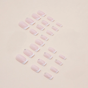 Square French press-on nails in light pink and white with small rhinestone accents