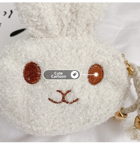Close-up of white plush bunny bag showing soft lambswool texture and embroidery