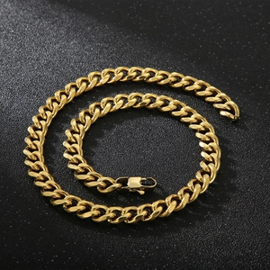 Detail of 11mm gold titanium steel Cuban link chain with lobster clasp on black background