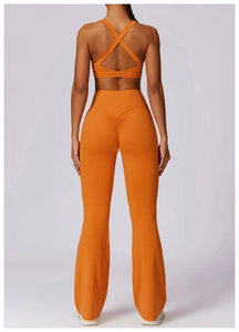 Detail of orange high-waist yoga pants with ruched butt lift and cross-back sports bra