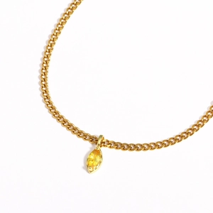 Detail of gold chain necklace featuring a marquise-cut yellow zircon pendant focal point