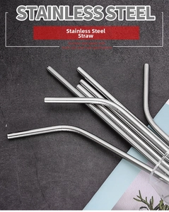 Macro shot of silver stainless steel straws with anti-slip texture on stone background