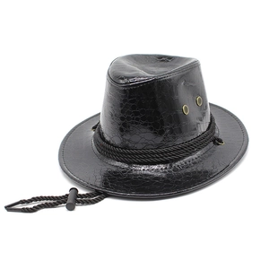 Detail of black faux leather cowboy hat with crocodile texture and metal ventilation eyelets