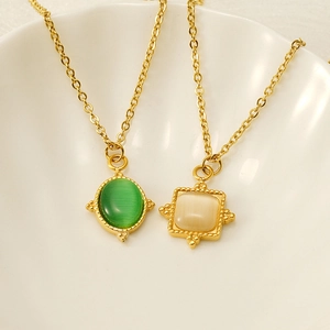 Detail of 18K gold stainless steel sun necklaces with green and white cat eye stones