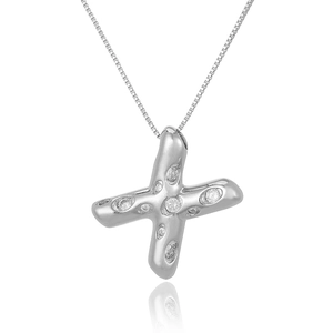 Detail of silver X-shaped necklace pendant with sparkling micro-paved cubic zirconia
