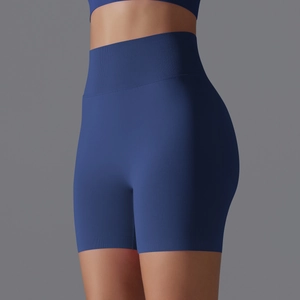 Close-up of seamless dark blue high-waisted fitness shorts with ribbed waistband texture