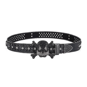 Macro shot of skull buckle and black rhinestones on a punk style leather belt