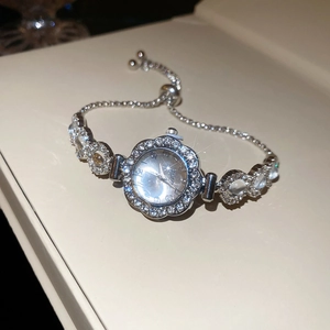Detailed macro view of silver floral watch bracelet with sparkling crystal rhinestones