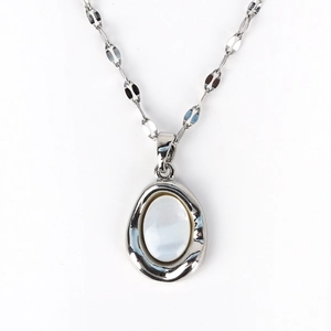 Close-up of a French vintage shell pendant with an irregular silver metal wavy frame
