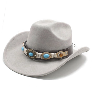 Detail of vintage suede cowboy hat with brown leather band and turquoise stone accents