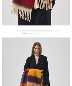 Detail of color-block striped scarf with tassels showing purple and burgundy wool texture
