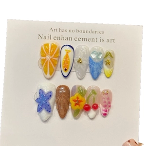 3D ocean-themed press-on nails with orange slices, sea stars and floral relief patterns