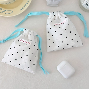 Detailed view of polka dot drawstring storage bags for cosmetics and accessories