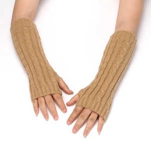 Close-up of cable knit arm warmers in beige featuring thumb holes and ribbed texture