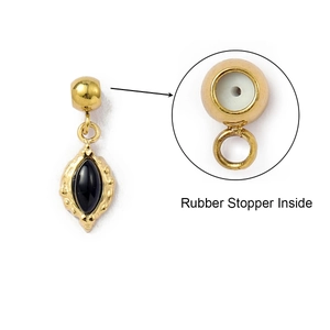 Detail showing the inner rubber stopper structure of the black stone gold charm